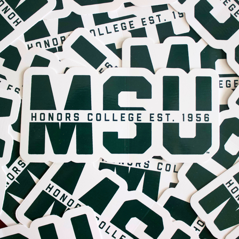 Forest green vinyl sticker outlined in white, featuring MSU block letters. Cutting through the block letters is a white strip with forest green text: “Honors College est. 1956”. 