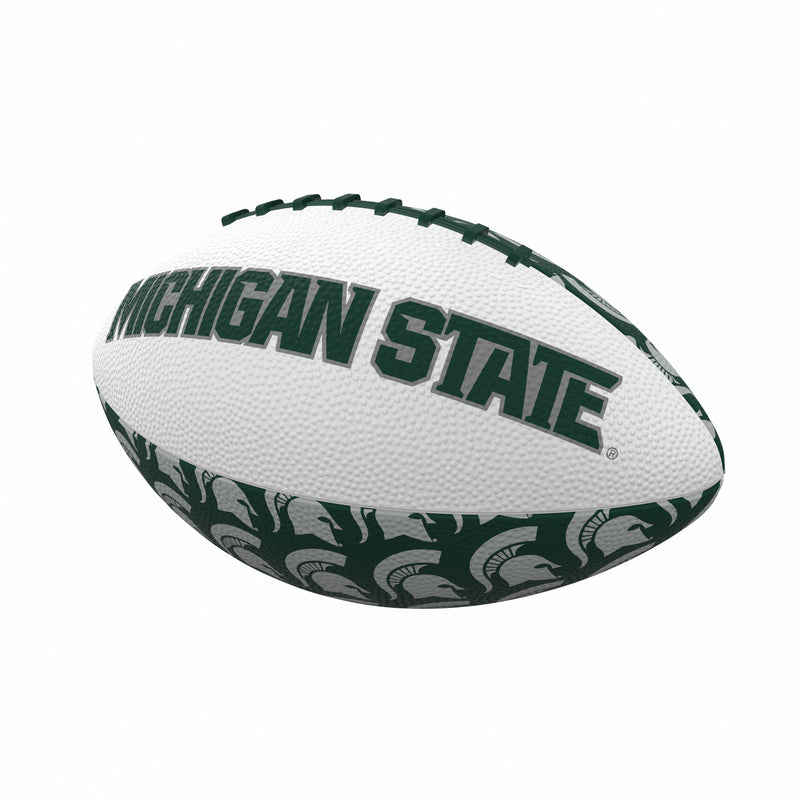 Four section rubber football where two sections are white featuring the text Michigan State and two panels are dark green with white Spartan helmets in a repeating pattern. The threads on the top of the football are green