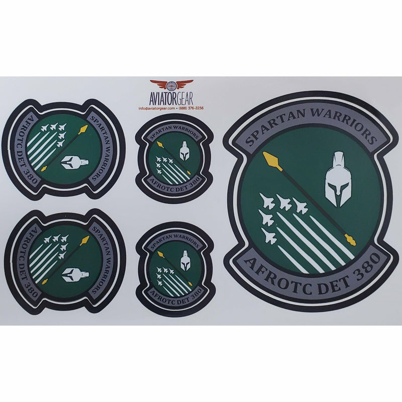 5 stickers of the AFROTC detachment 380 logo (5 fighter jets, a spear, and a spartan helmet in a green circle. Silver bars jut out on the top and bottom reading Spartan Warriors and AFROTC DET 380, respectively) on a sheet