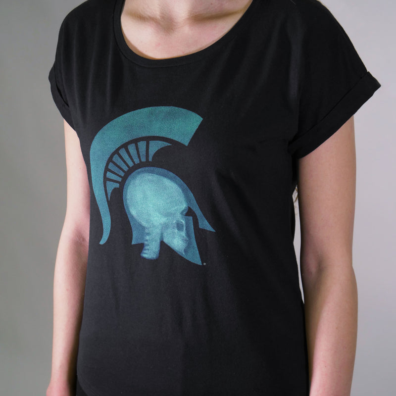 Woman wearing Black Short-sleeve t-shirt with a scoopneck with a graphic of a head wearing a Spartan helmet being x-rayed