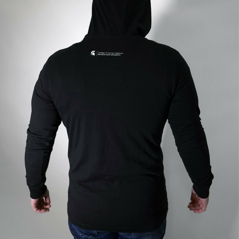 Back of a man wearing the black long-sleee t-shirt with the hood up. Under the hood is the College of Human Medicine signature logo