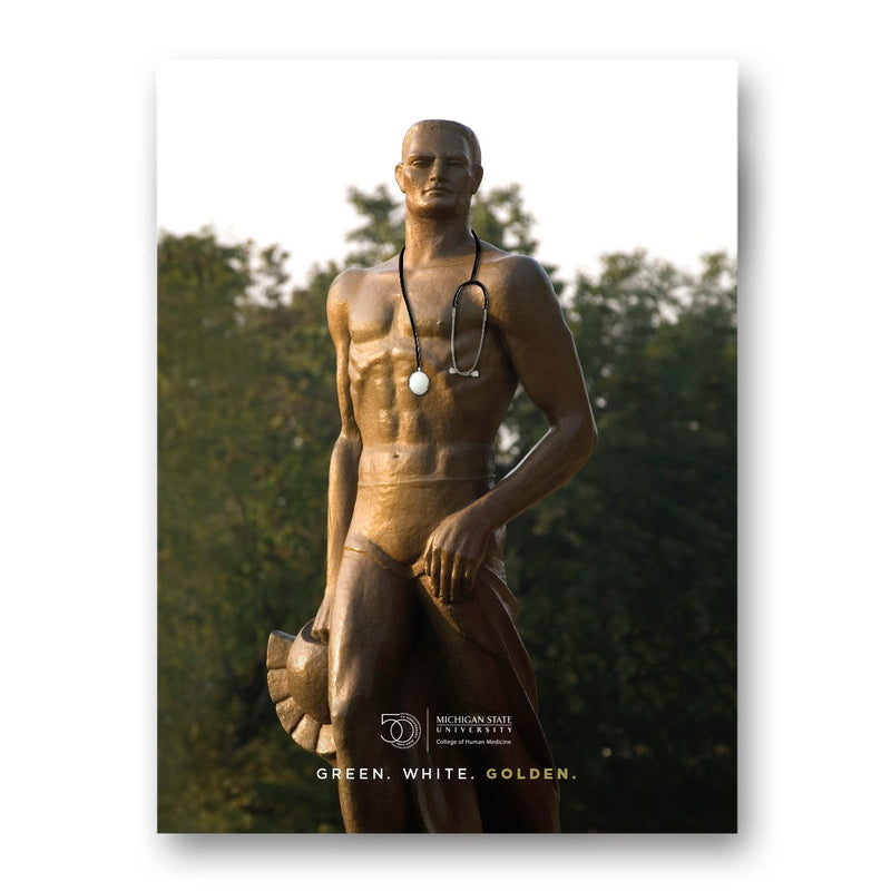Sparty statue in the golden hour wearing a black and silver stethoscope. Underneath the College of Human Medicine's 50th anniversary wordmark logo is text reading Green, White, Golden