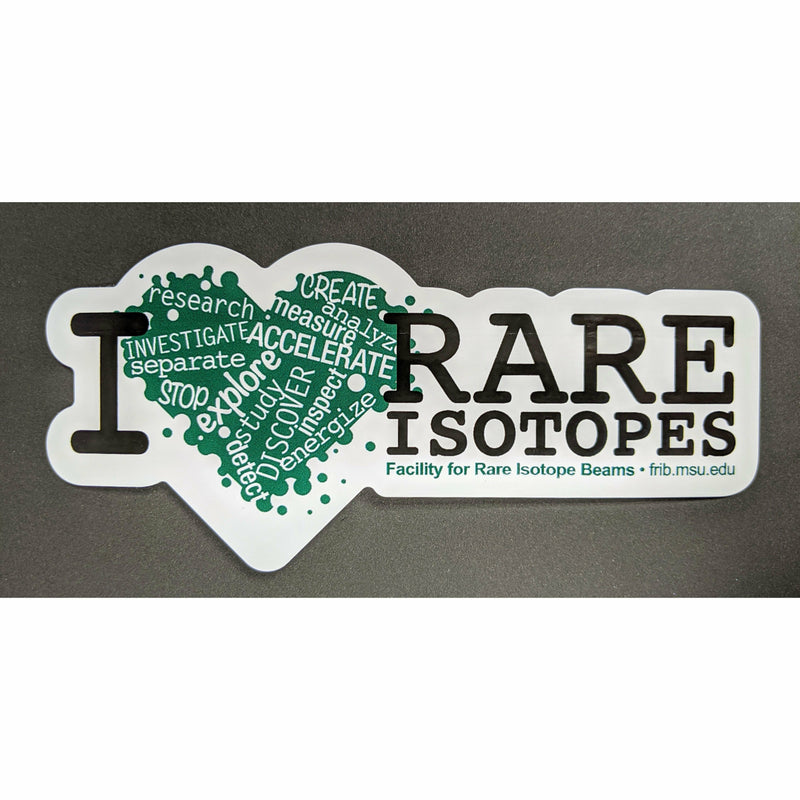 A kelly green heart with a variety of words cutout in white such as accelerate, explore, and discover. To the left is a large black serif letter I, with two lines of the same font on the right-hand side spelling out "rare isotopes." Below the isotopes line, kelly green text reads "Facility for Rare Isotope Beams, FRIB.MSU.EDU." The sticker has a thick white border that follows the shape of the graphics and text.