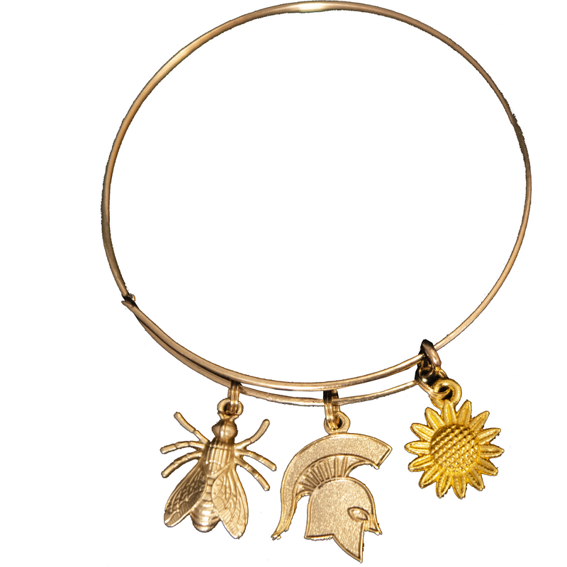 Gold bangle-style bracelet with three charms. From left to right: a golden bee, a gold Spartan helmet, and a yellow sunflower.