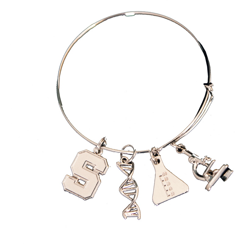 Silver bangle-style bracelet with four charms. From left to right: block S, DNA double-helix strand, Erlenmeyer flask, and a microscope (all in silver).