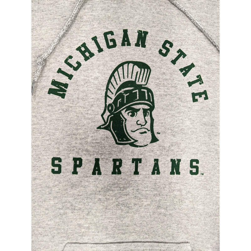 Close-up of a green screen printed vintage rendition of Sparty's head is printed between arched text reading Michigan State and a straight line of text reading Spartans.