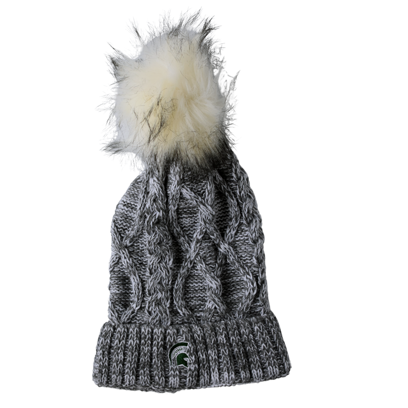 Cable knit beanie hat, knit in a variety of gray shades. On top is a furry pom-pom that is cream in color with gray tips. On the hat's brim, a small green Spartan helmet is embroidered with a white edge.