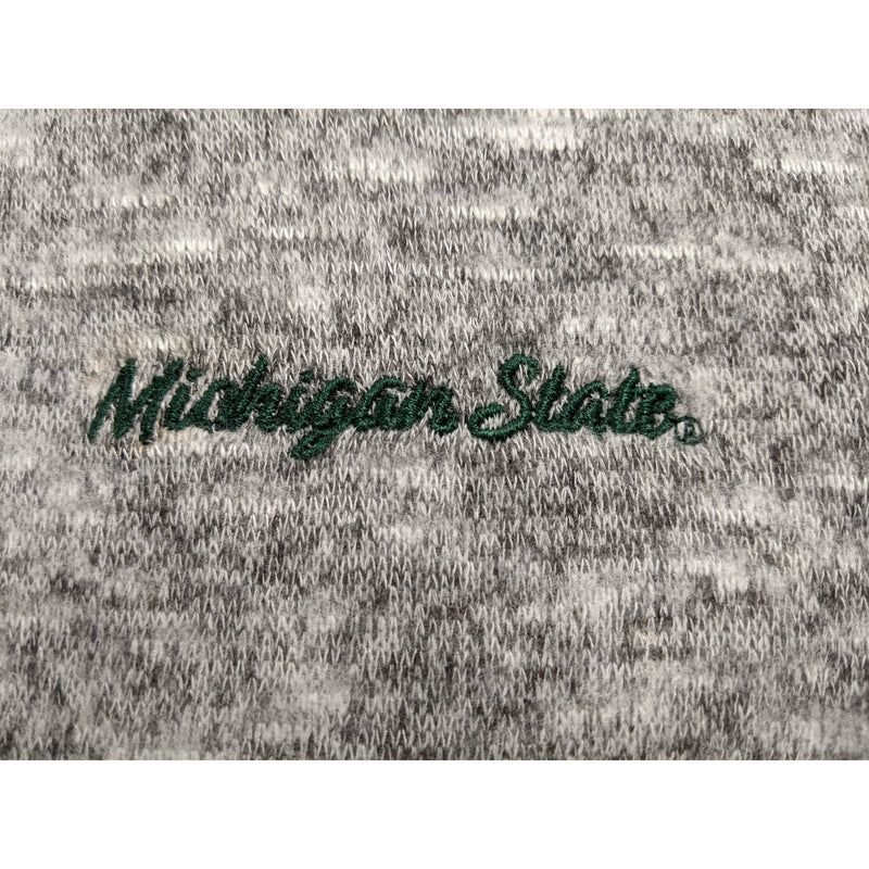 Close-up of the dark green embroidery on the left chest, which reads Michigan State in script font
