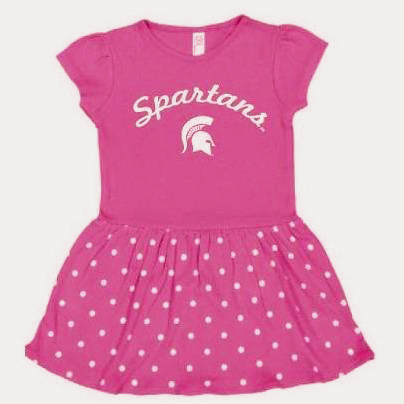 Pink dress with cap sleeves and a crewneck. The skirt is ruffled with a white polka dot pattern. Printed in white on the center chest is Spartans in script font above a Spartan helmet. 