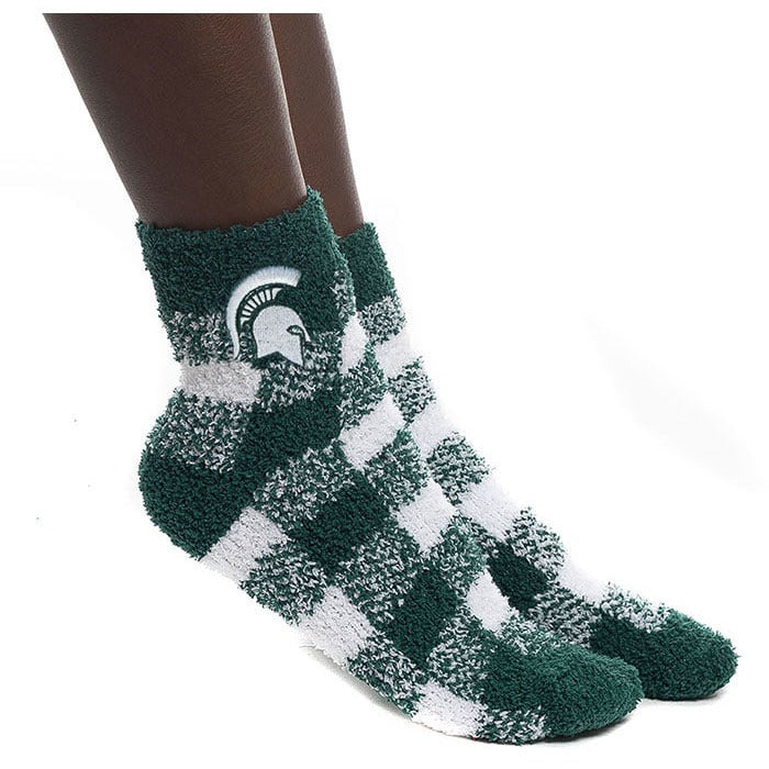 Green and white fuzzy socks in a buffalo check plaid pattern. The toe and heel are both dark green. Just under the cuff is an embroidered white Spartan helmet with green edges.