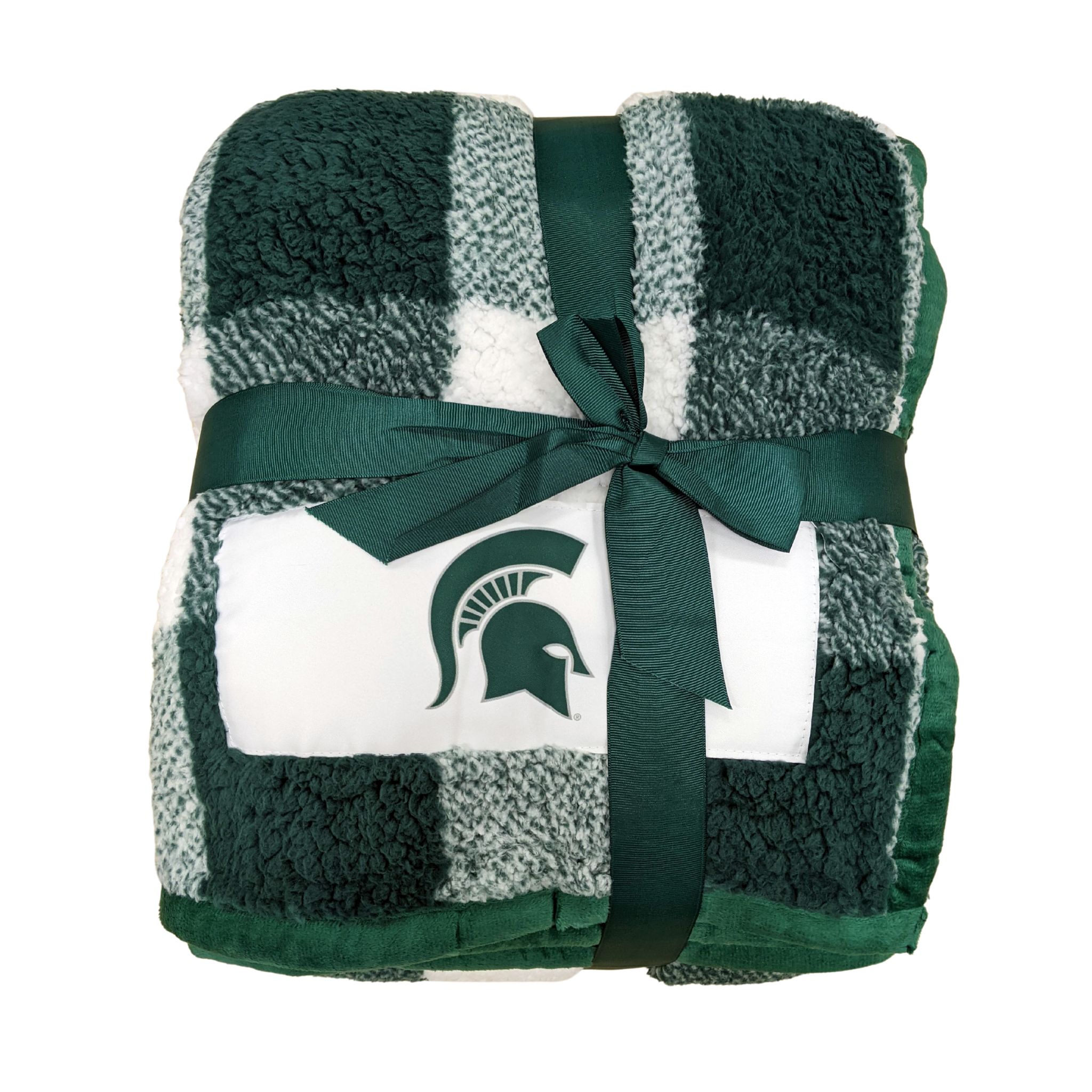 Green and white buffalo plaid fuzzy blanket wrapped into a neat square and tied with a dark green ribbon. On one corner is an embroidered green Spartan helmet, and the blanket's edging a piped dark green fabric.