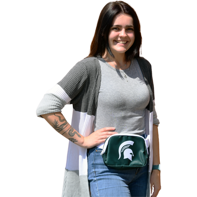 Woman wearing the green fanny pack with white Spartan helmet logo on her right hip