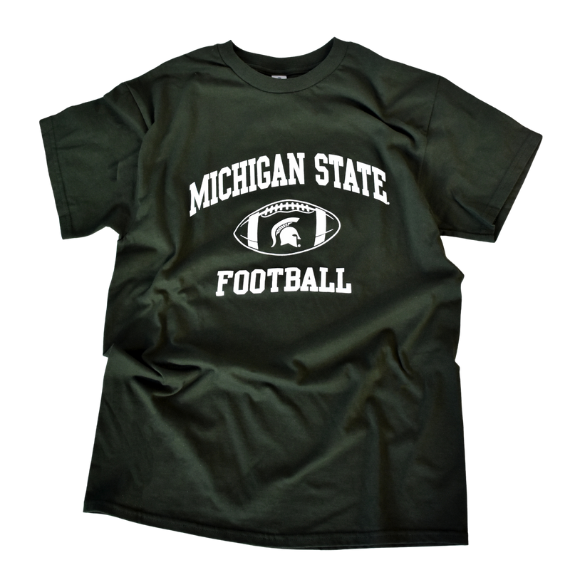 Forest green crewneck short-sleeve t-shirt. In block letters on the center chest is an arch reading Michigan State over a football outlines with a Spartan helmet in the center. Below that is a block letter line reading Football.