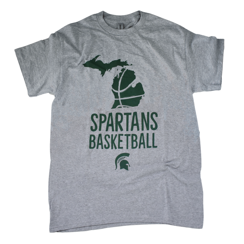 Light heather gray t-shirt with forest green printing. Centered at the top of torso is the state of Michigan, with the lines of a basketball cut into the lower peninsula. Below that is text reading Spartans basketball in all caps on two lines, with a small Spartan helmet centered underneath.