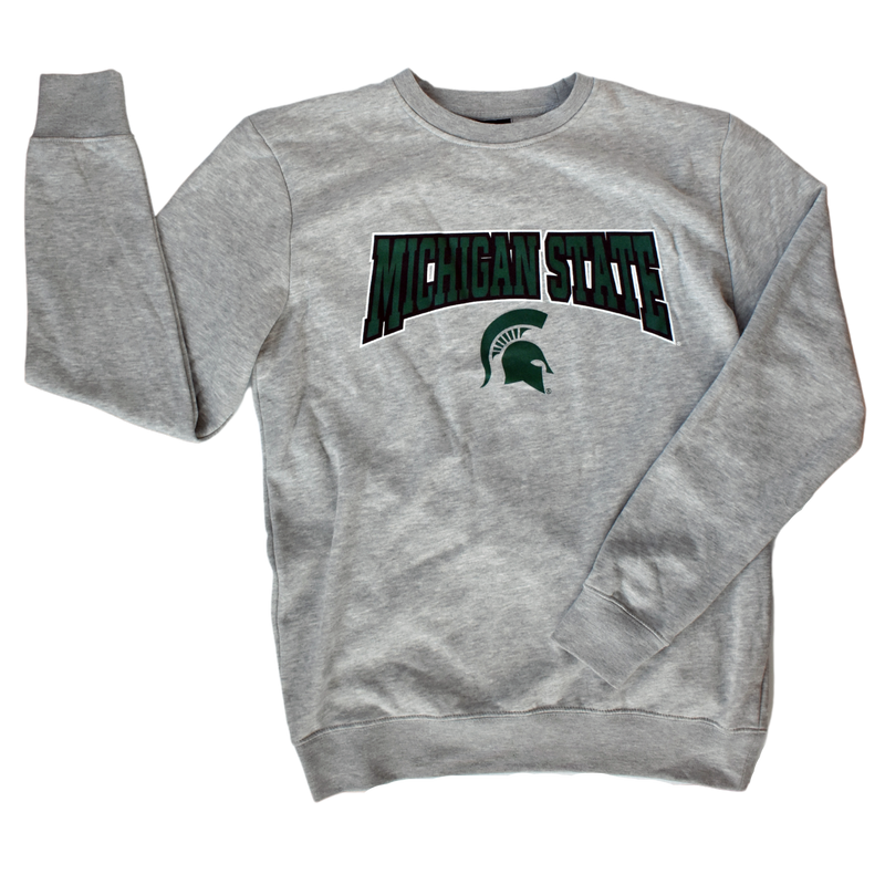 Light heather gray crewneck sweatshirt. Printed in dark green with black and white outlines on the center chest is bold block letters spelling Michigan State in a slight arch, which is over a medium-sized green Spartan helmet.