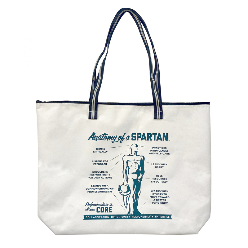 White zippered tote bag with a black and white striped handle. Graphic in green reads Anatomoy of a Spartan and a variety of descriptive qualtities, including thinking critically and leads with heart.